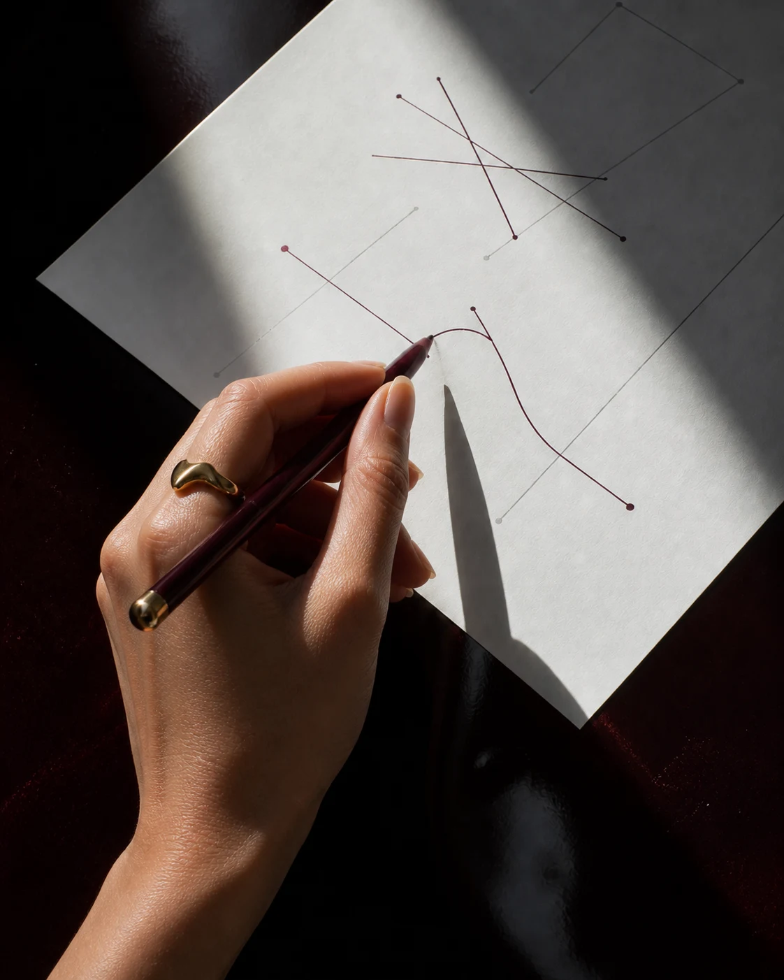 A woman's hand connecting and correcting decisions on a working page